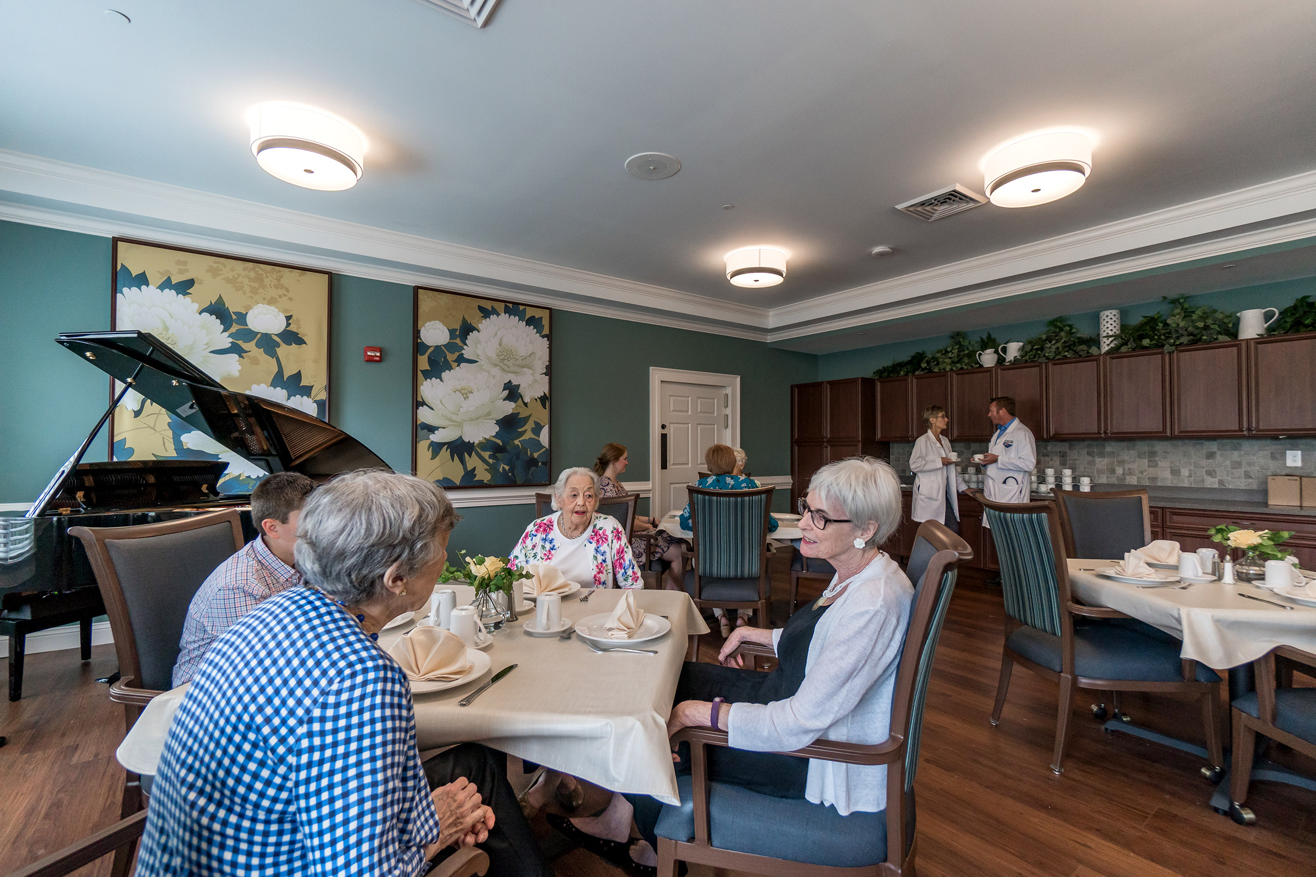 Residents and guests enjoying the main dining room